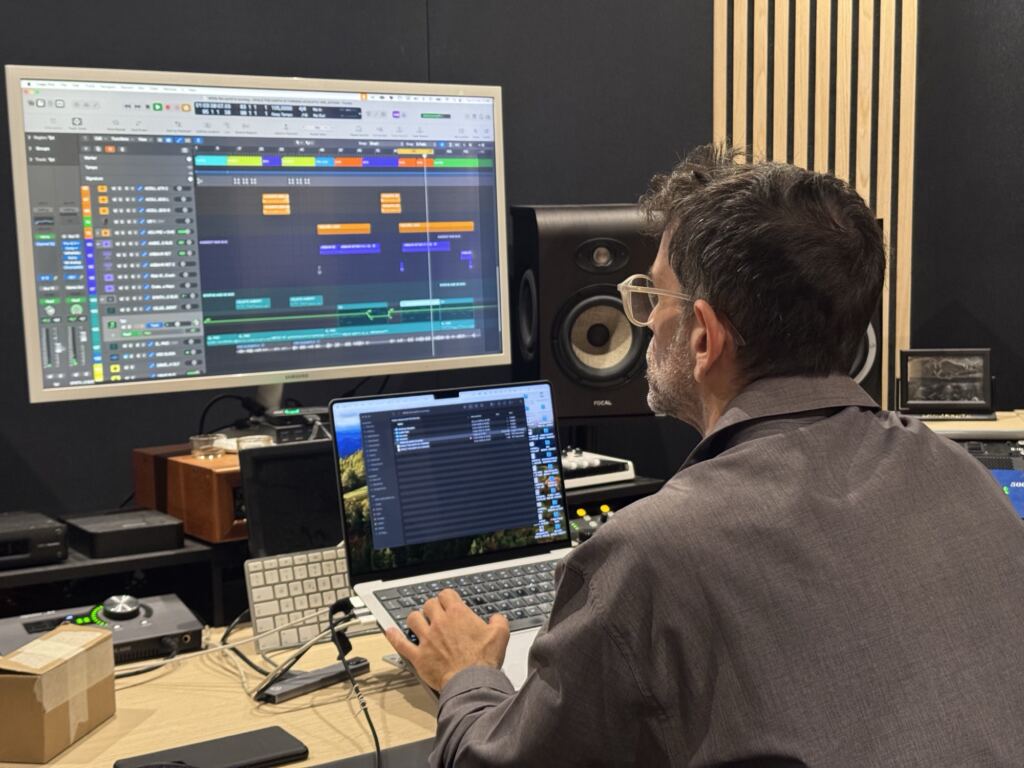 Adriano Russo al banco dello studio, davanti alla sessione aperta sul monitor